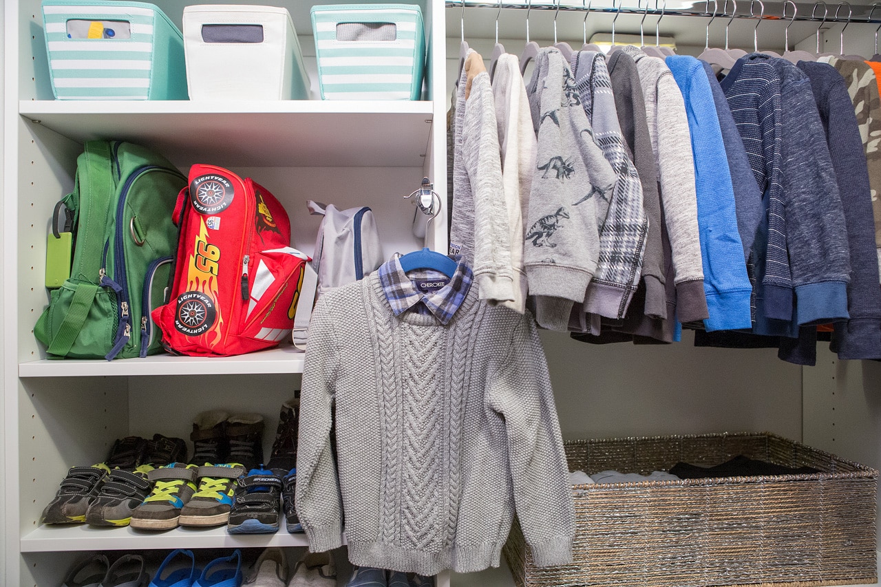 Inspired Closets walk in closet with shelves for clothes and other belongings and clothing racks