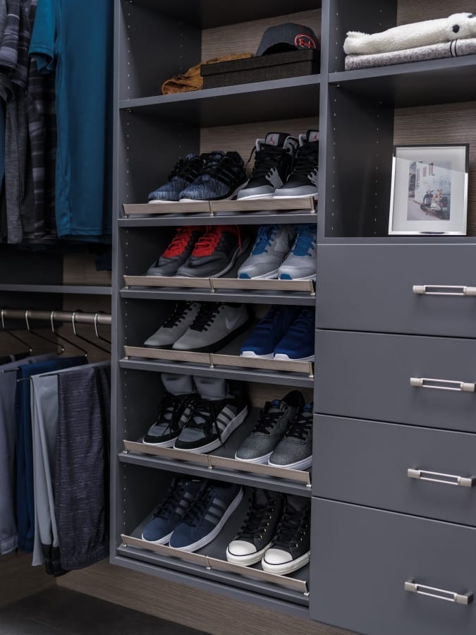 Clothing hung on racks and shoes placed on shelves