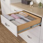 Dresser drawer pulled out with folded clothing inside