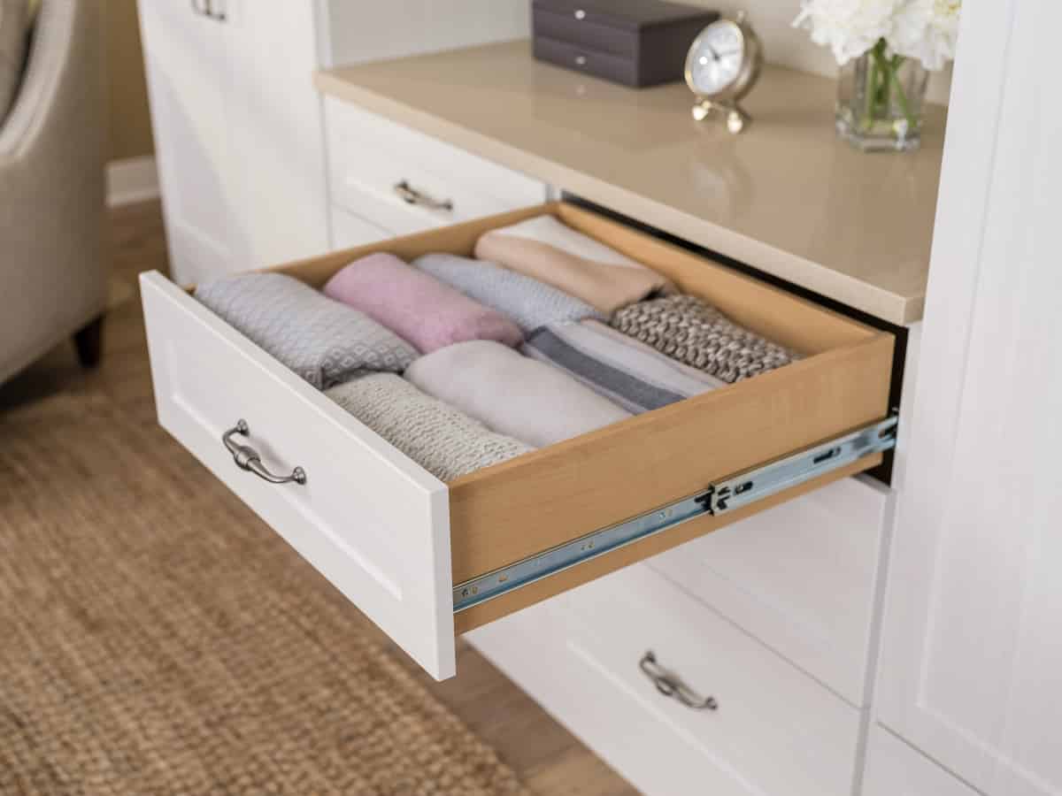 Dresser drawer pulled out with folded clothing inside