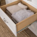 Dresser drawer pulled out with folded clothing inside