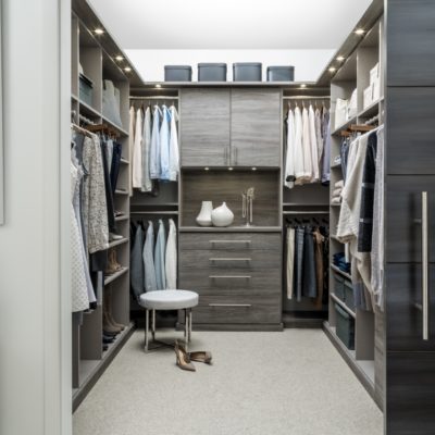 Walk in closet full of clothing on shelves, racks and in drawers