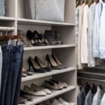 Shirts hung on racks and shoes placed on shelves