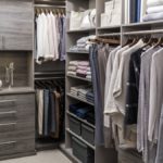 Closet filled with clothing on racks and placed on shelves