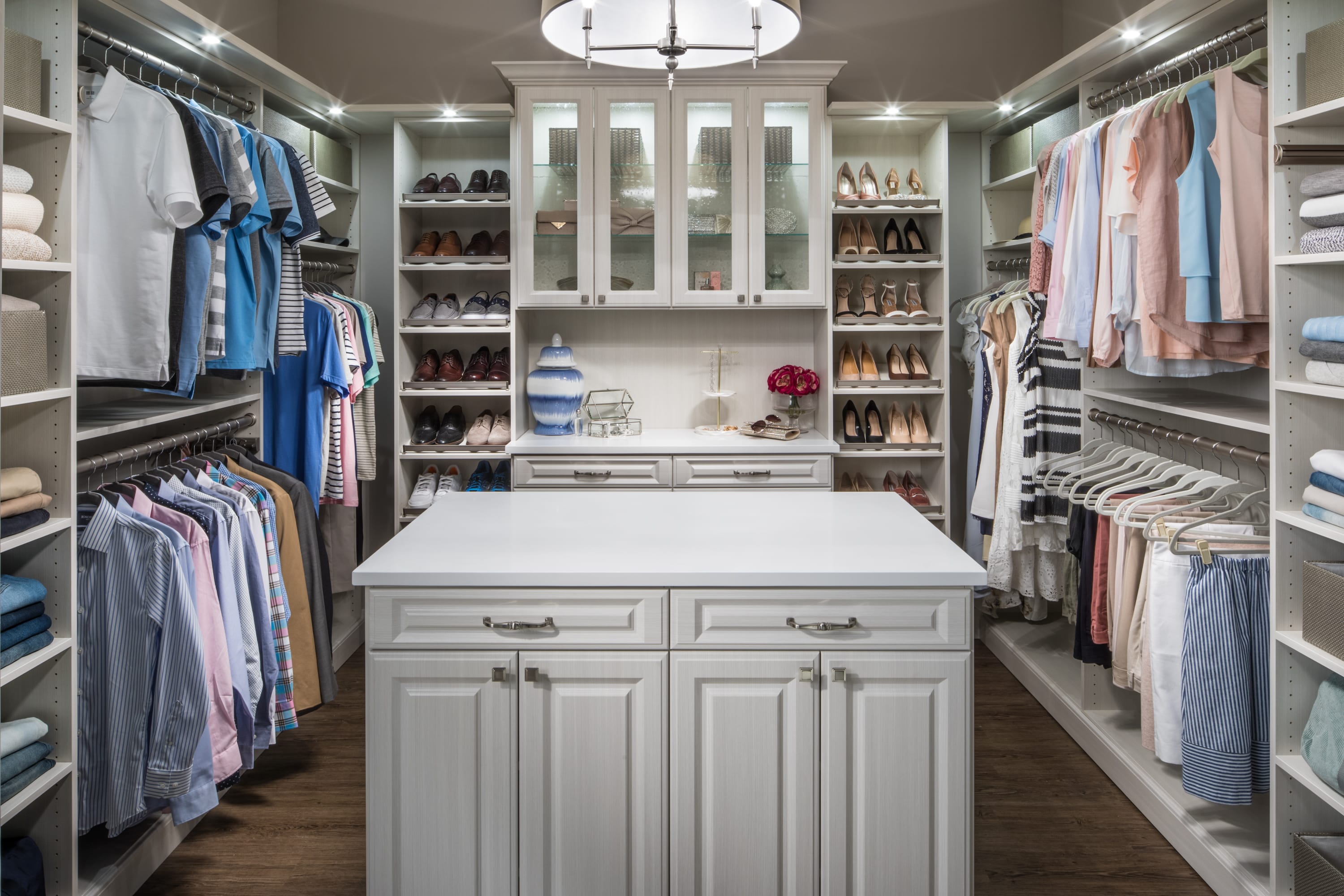 Boutique closet with clothing on shelves, in racks, and in drawers and cabinets