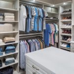 Boutique closet with clothing on shelves, in racks, and in drawers and cabinets