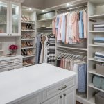 Boutique closet with clothing on shelves, in racks, and in drawers and cabinets