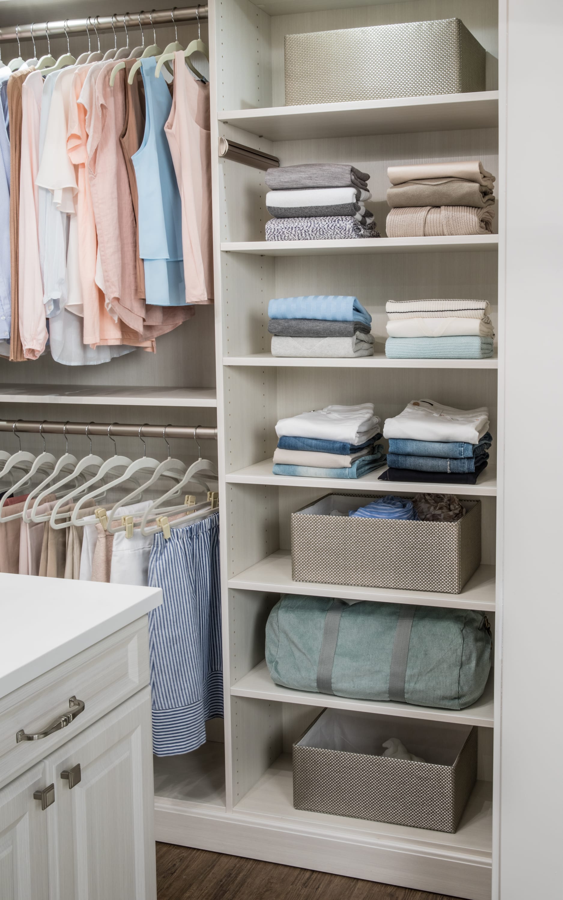 Clothes and other articles on shelves with shirts and pants hung on racks