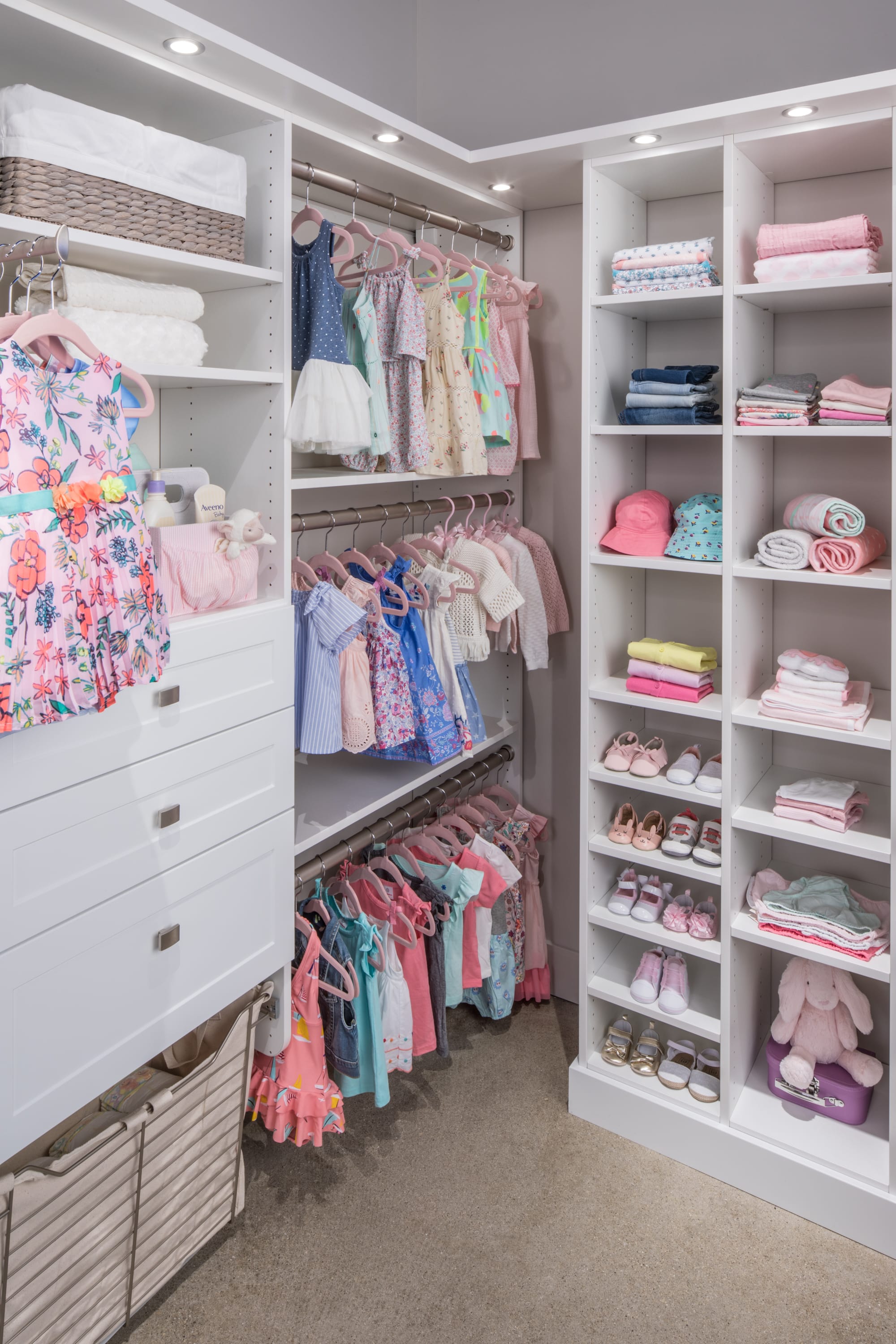 Girls walk in closet with clothing on racks and shelves