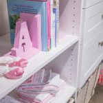 Close up of girls closet with shelves, drawers and racks