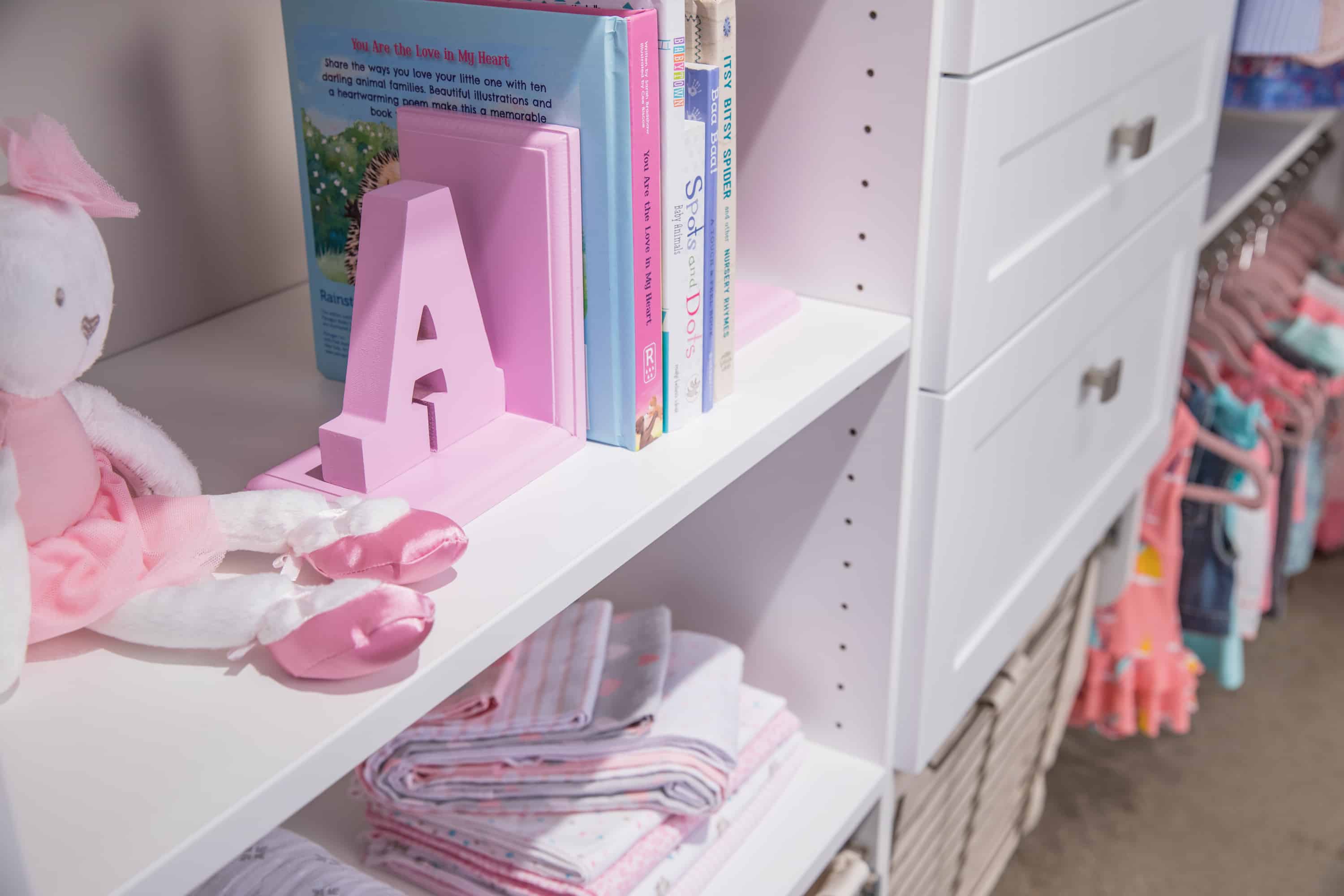 Close up of girls closet with shelves, drawers and racks