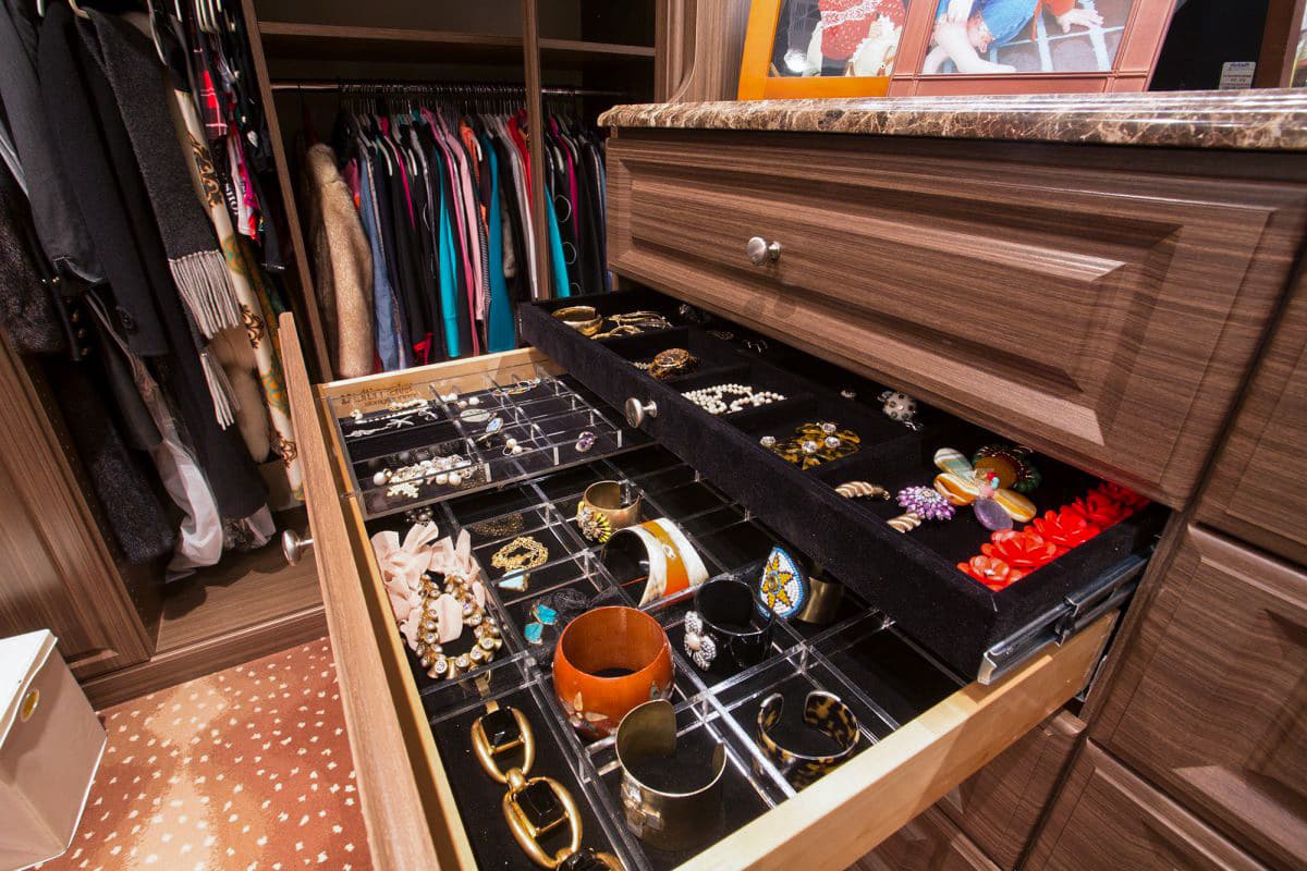 Inspired Closets boutique custom closet systems with open drawer showing belongings inside