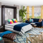 Bedroom full of furniture and murphy bed folded out onto ground