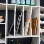 Cutting boards placed in compartments in kitchen shelves