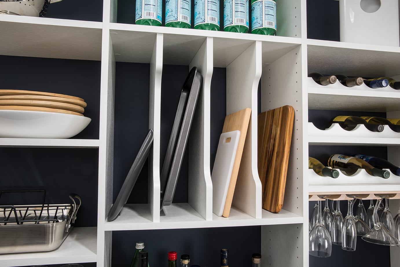 Cutting boards placed in compartments in kitchen shelves