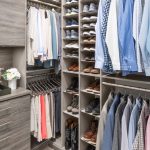 Closet with clothing on racks, shoes on shelves and dresser with closed drawers