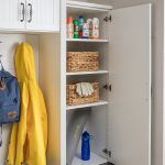 Entry way closet with cabinet open for personal belongings