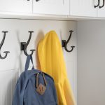 Backpack and jacket hung on an entryway closet hook