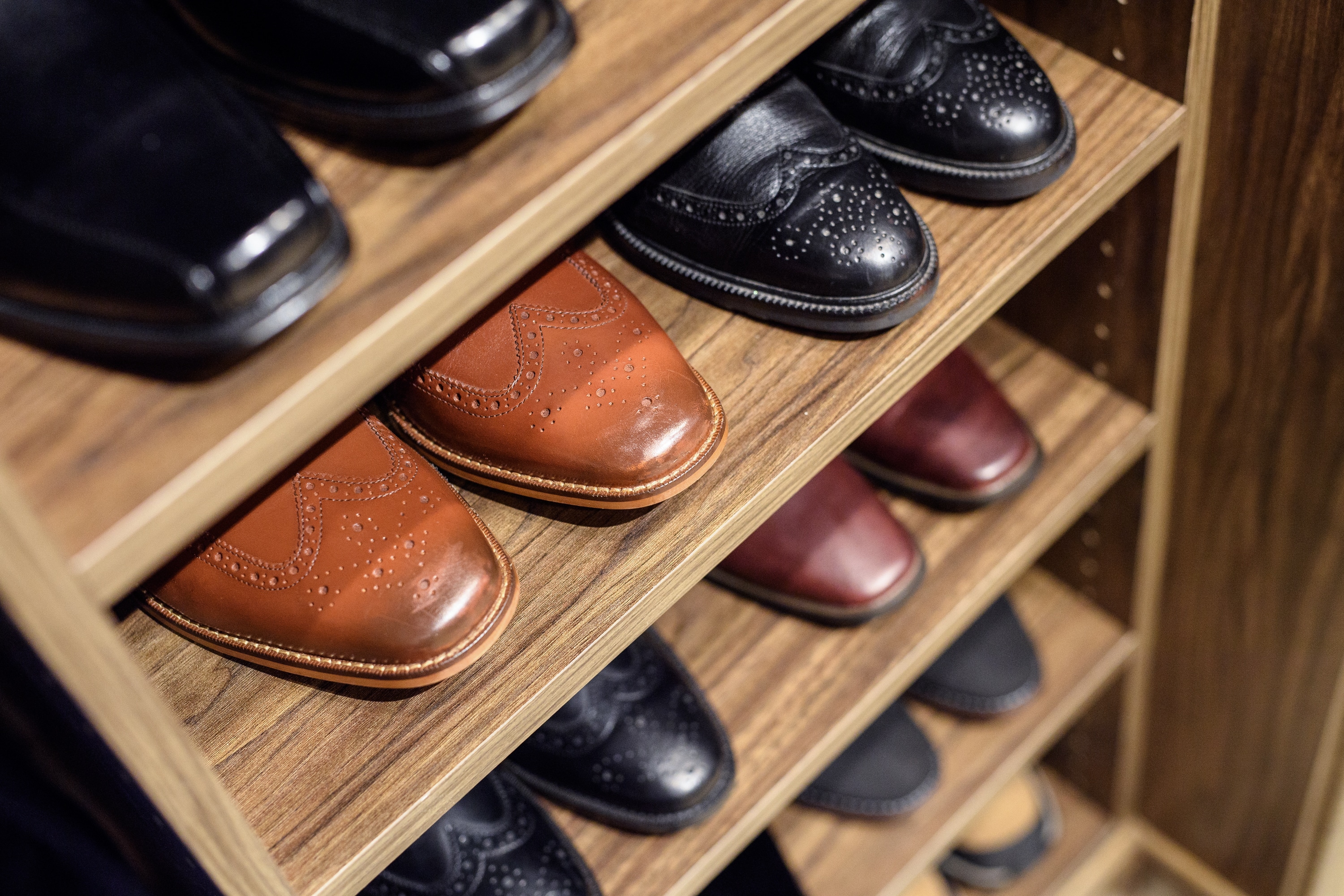Close up of men's shoes on shelves