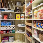 Pantry with items hung on wall and food on shelves