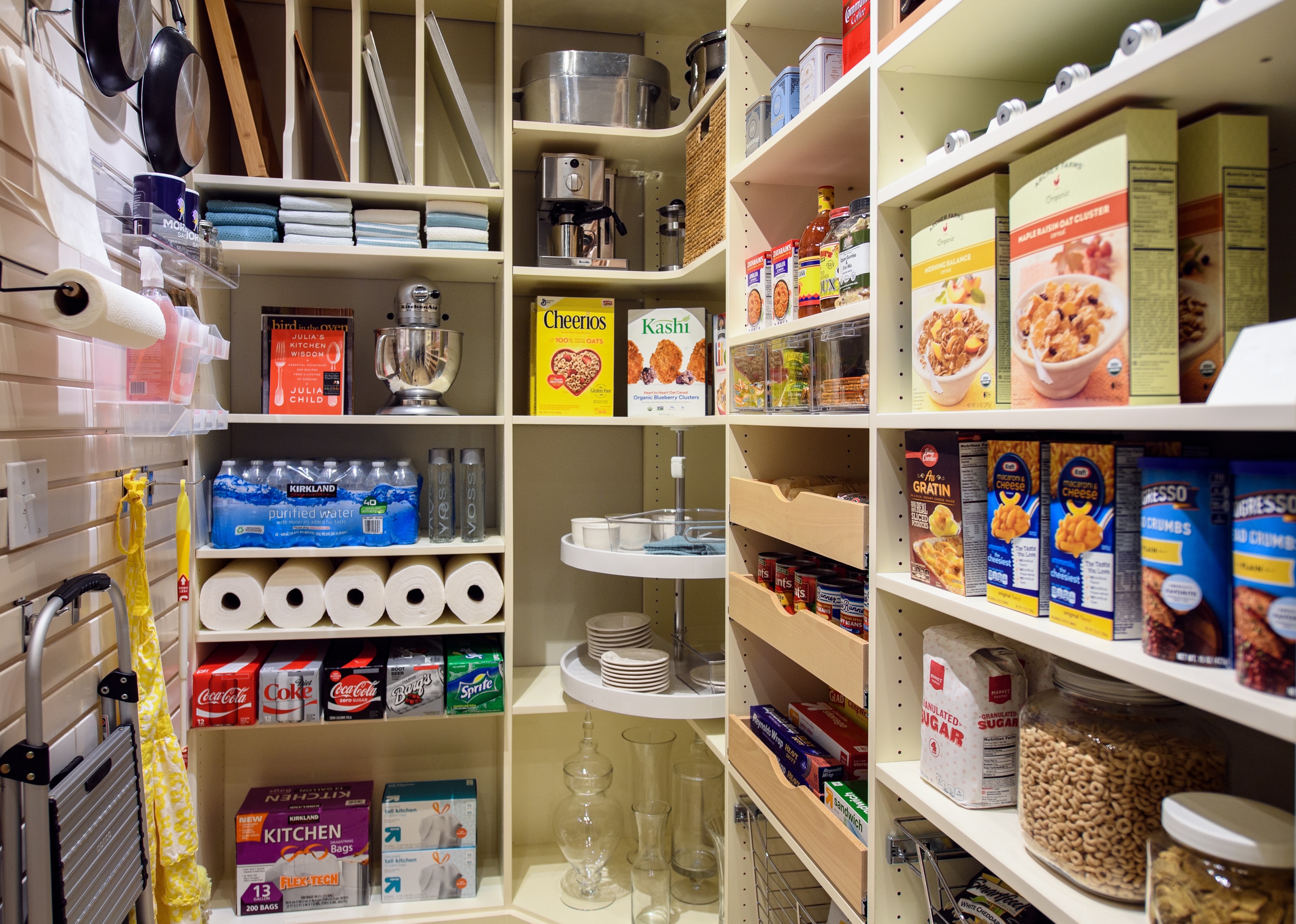 Pantry with items hung on wall and food on shelves