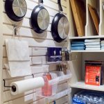 Kitchen items hung on wall by hooks