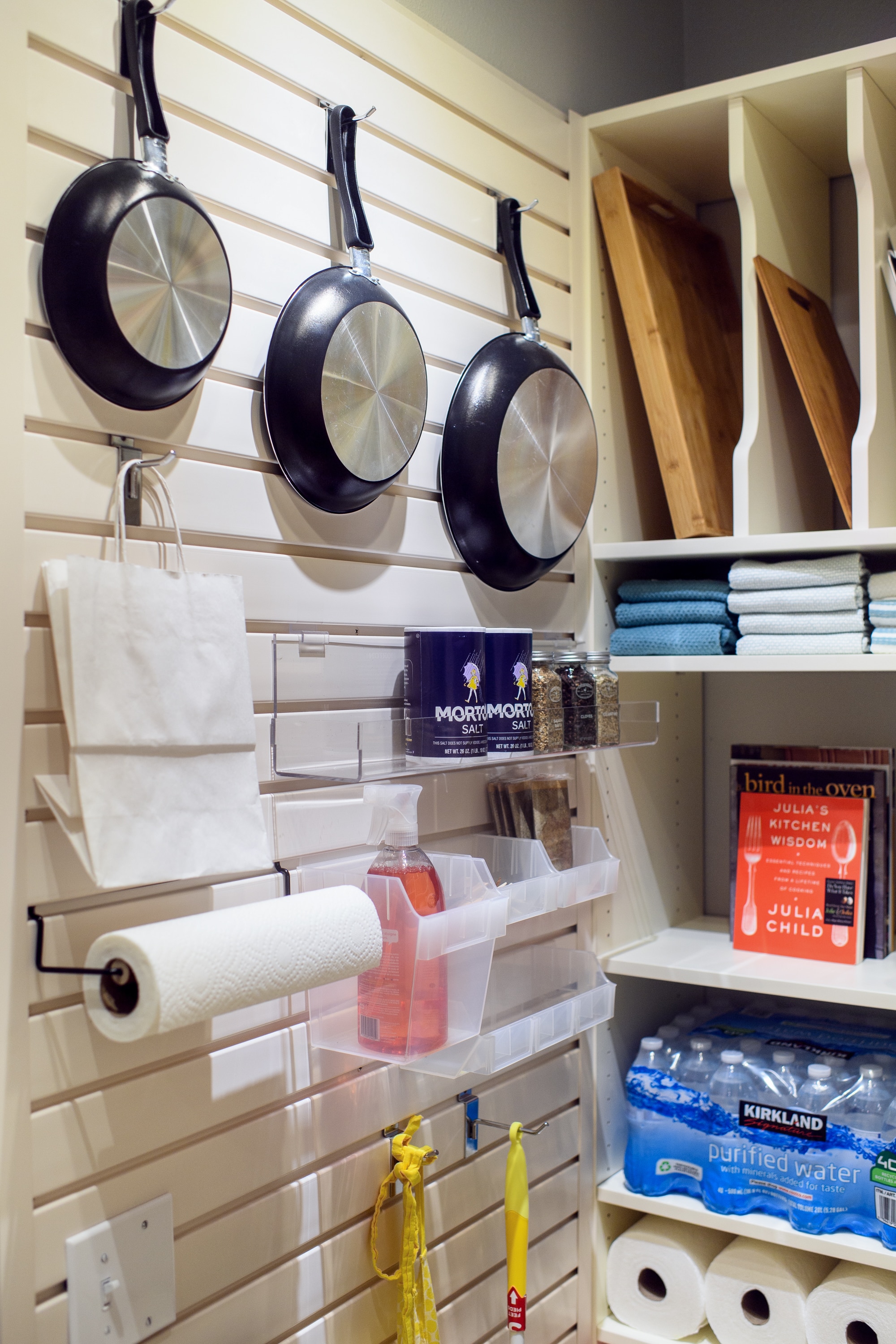 Kitchen items hung on wall by hooks