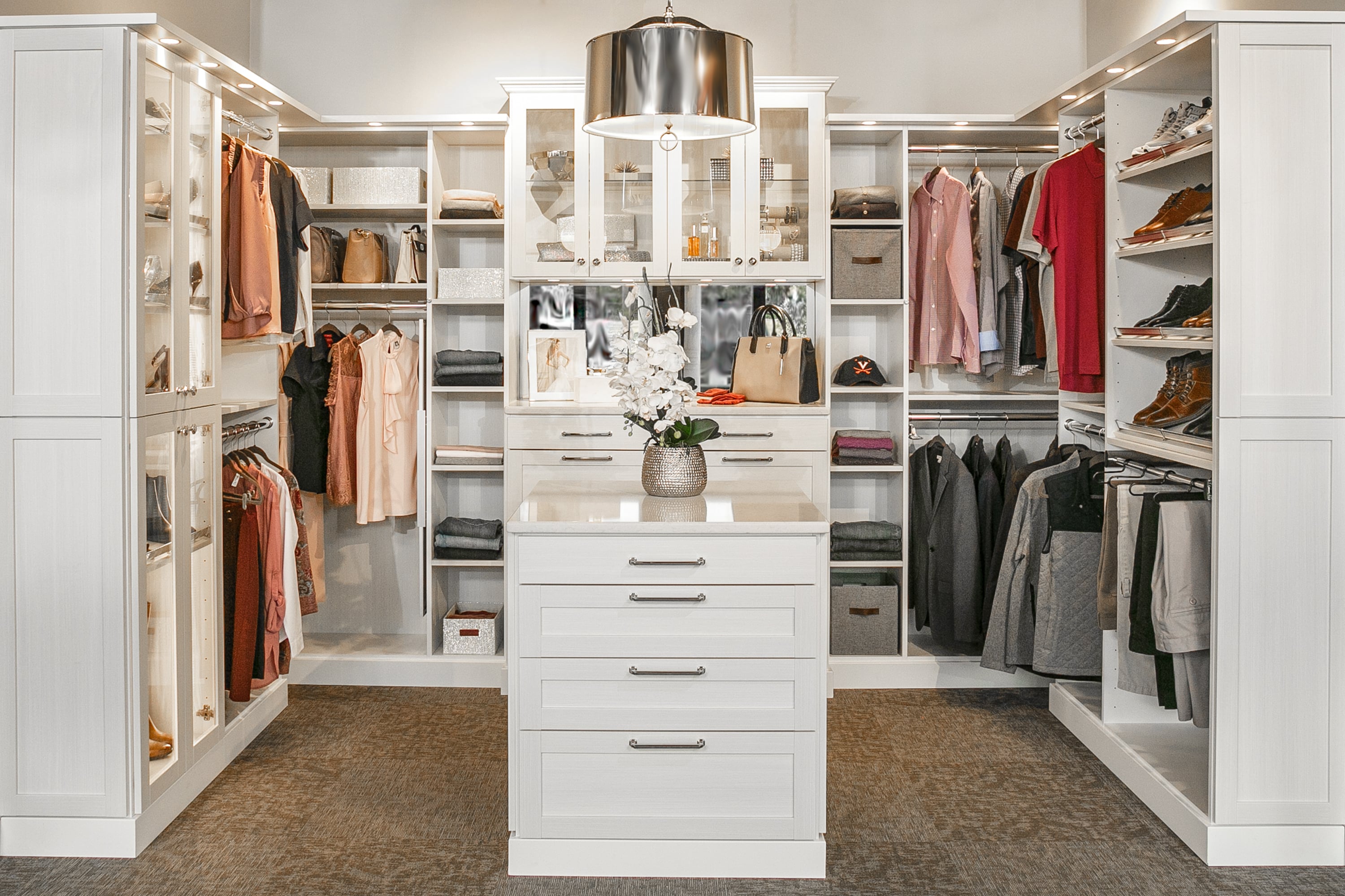 closet with shoes on shelves, clothing on racks and other articles in cabinets