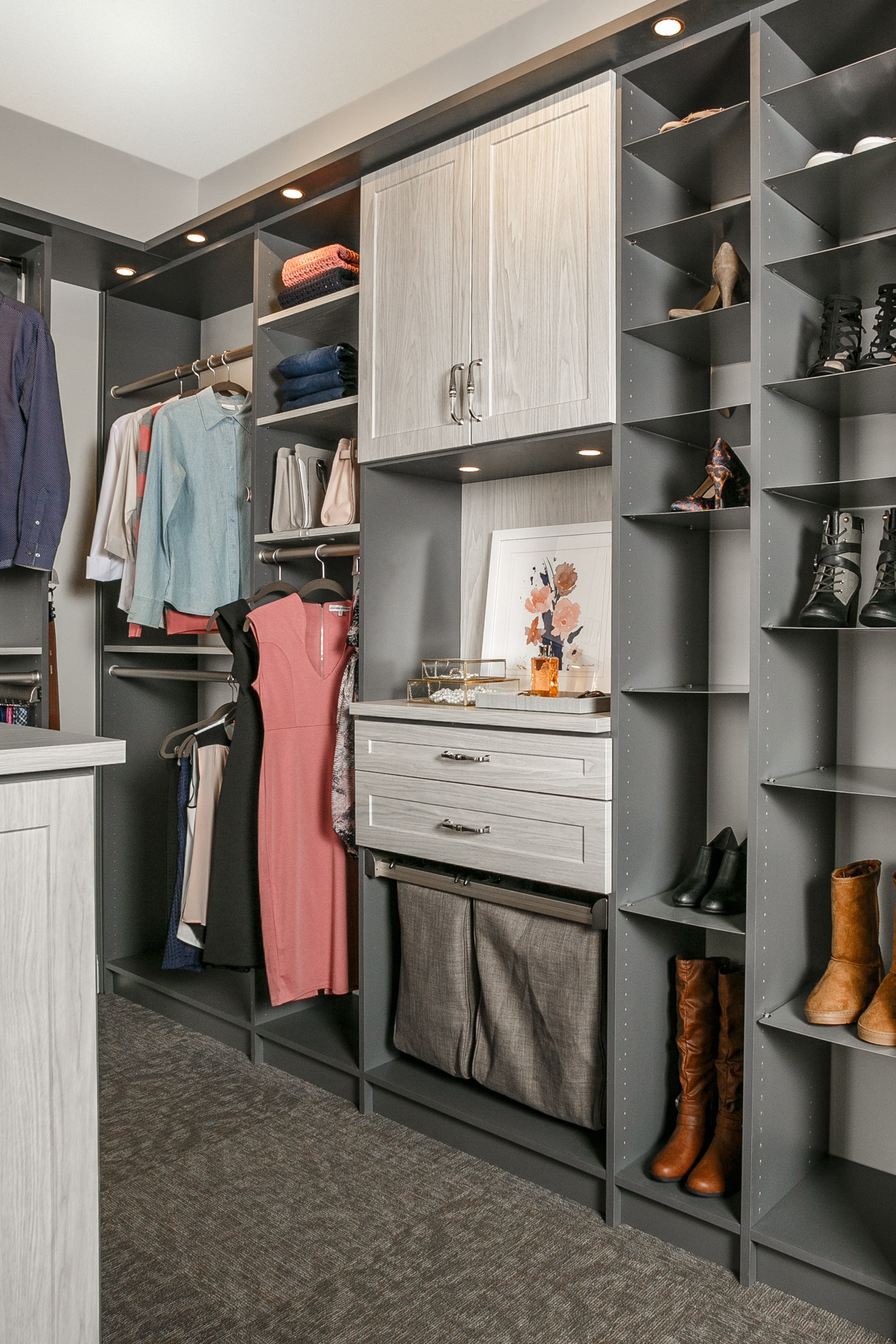 Side view of closet showing shelves, clothing racks and drawers