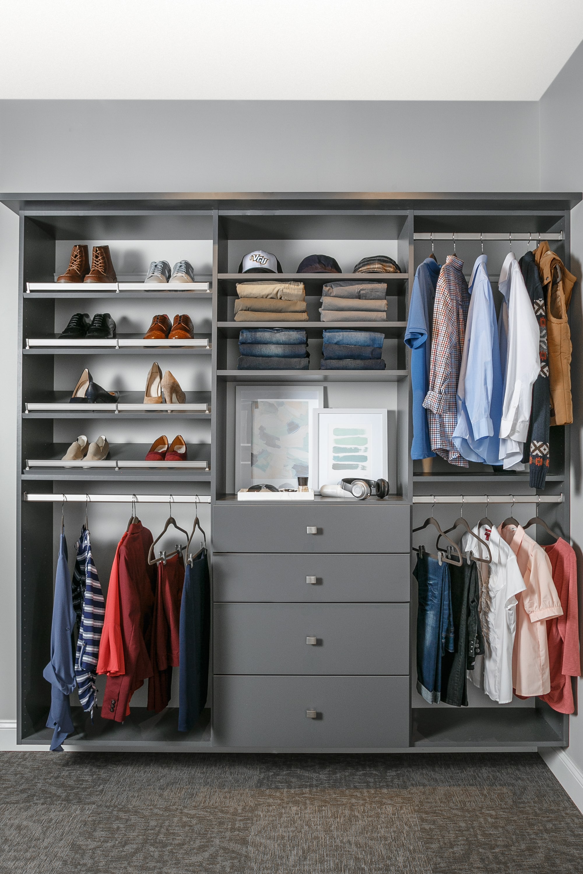 Reach in closet showing drawers, shelves and racks full of clothing