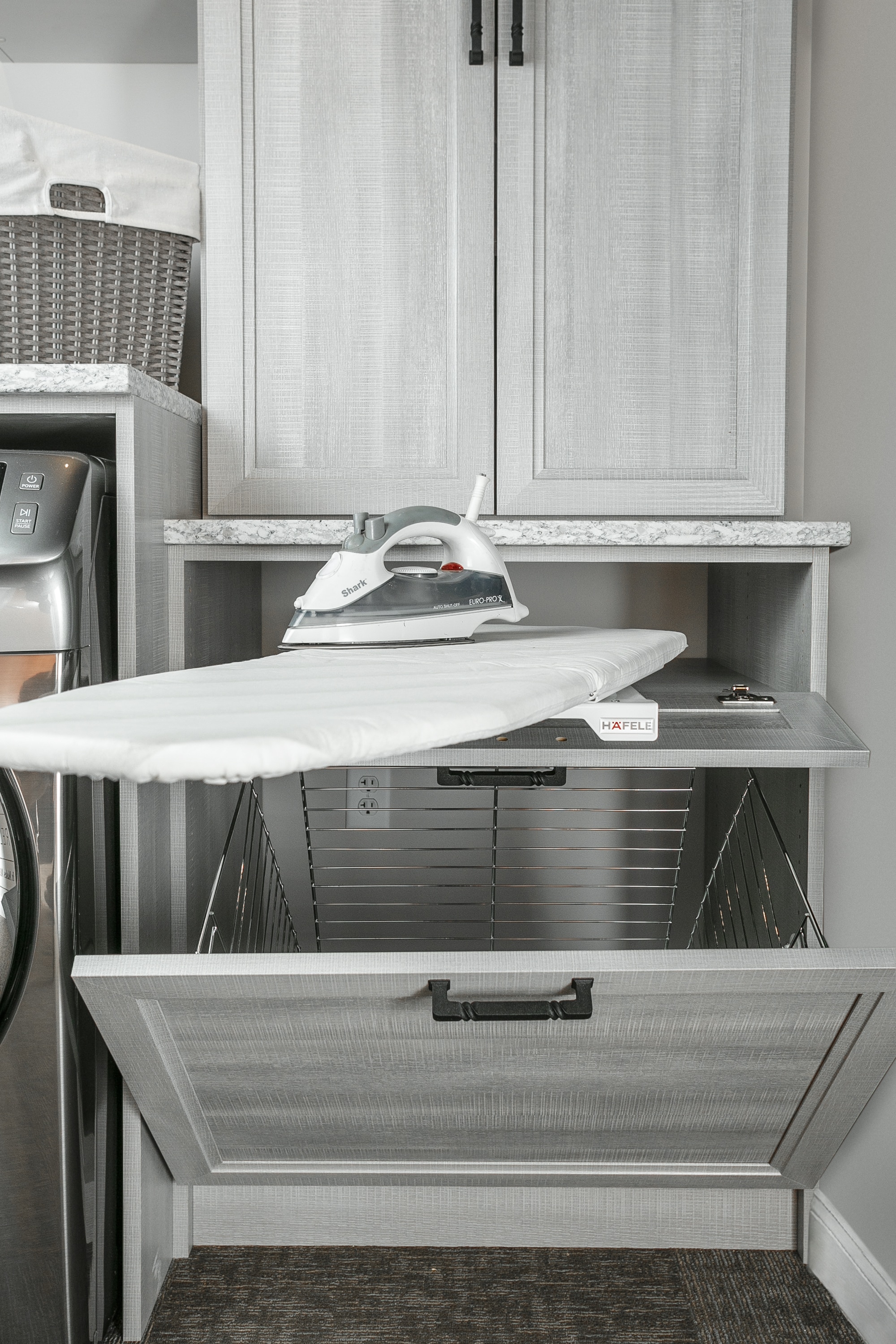 Laundry closet with drawer pulled out with space for ironing board