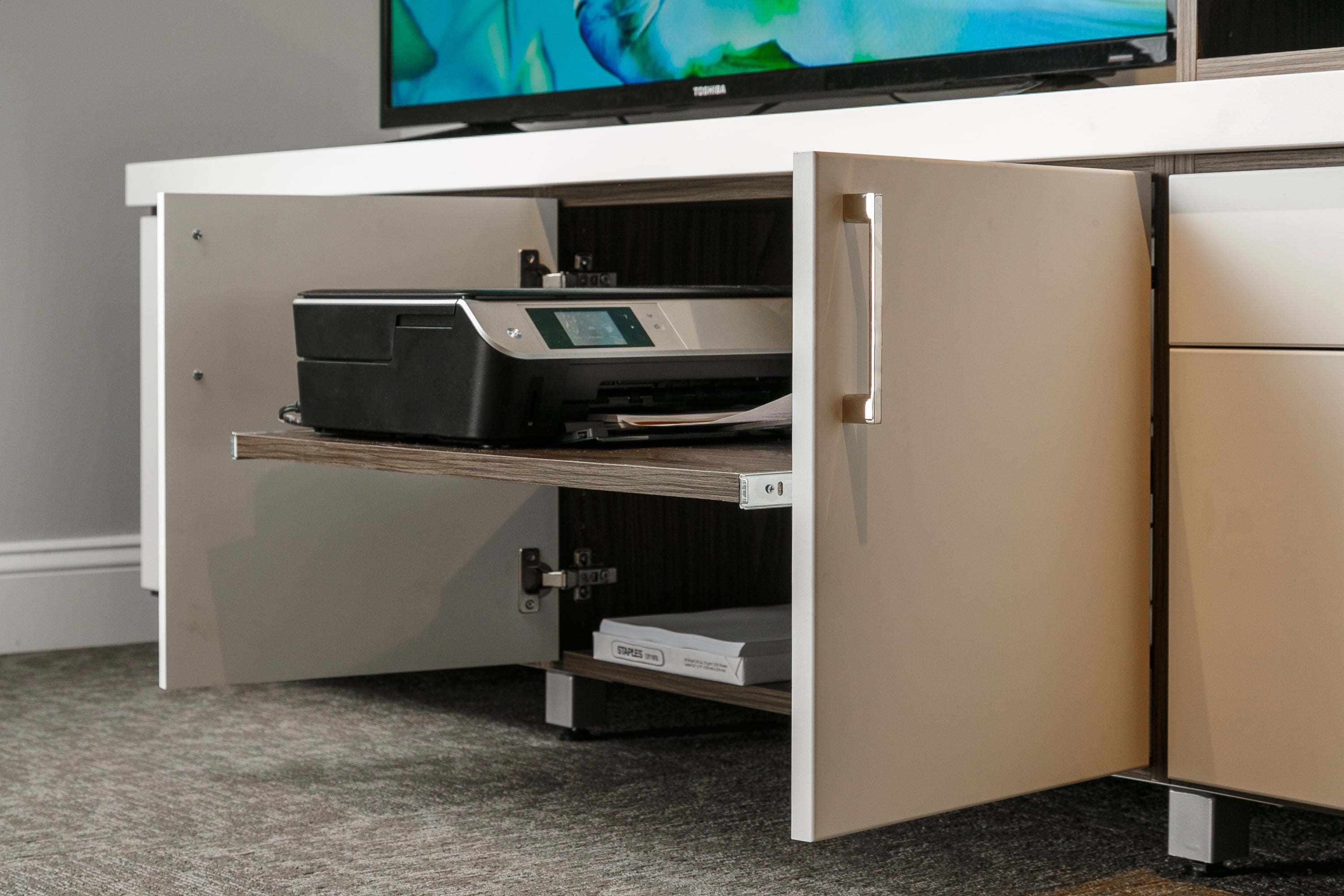 Entertainment center with cabinet pulled out showing printer and paper