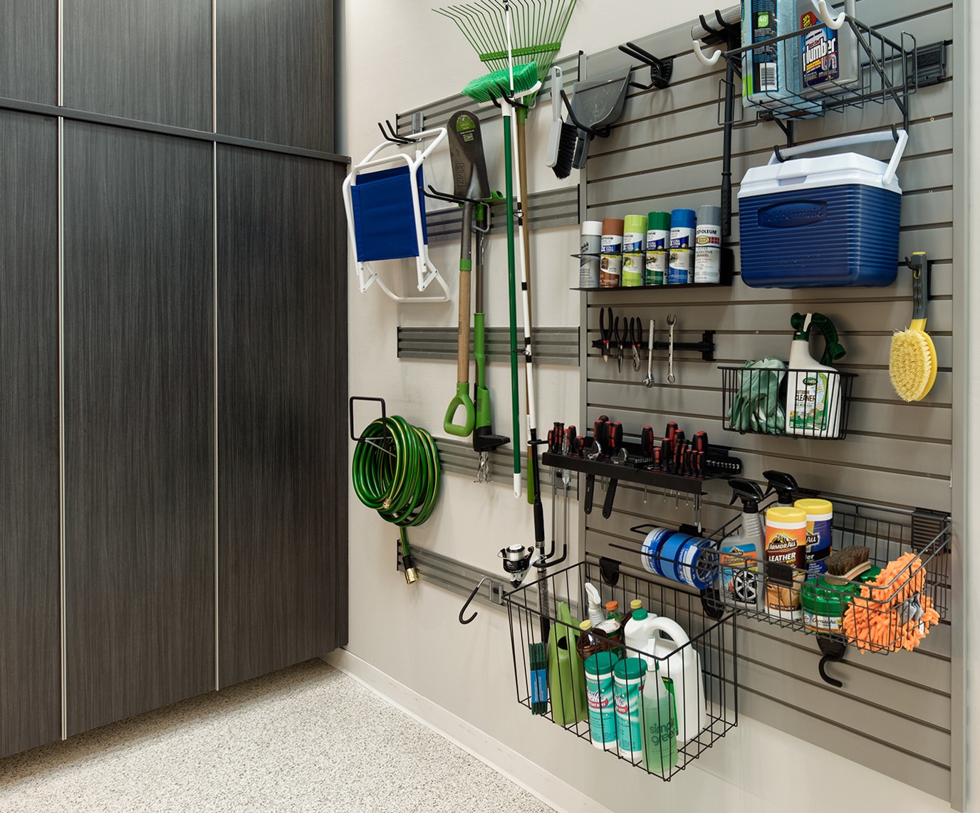 tools hanging on wall in garage with mounts