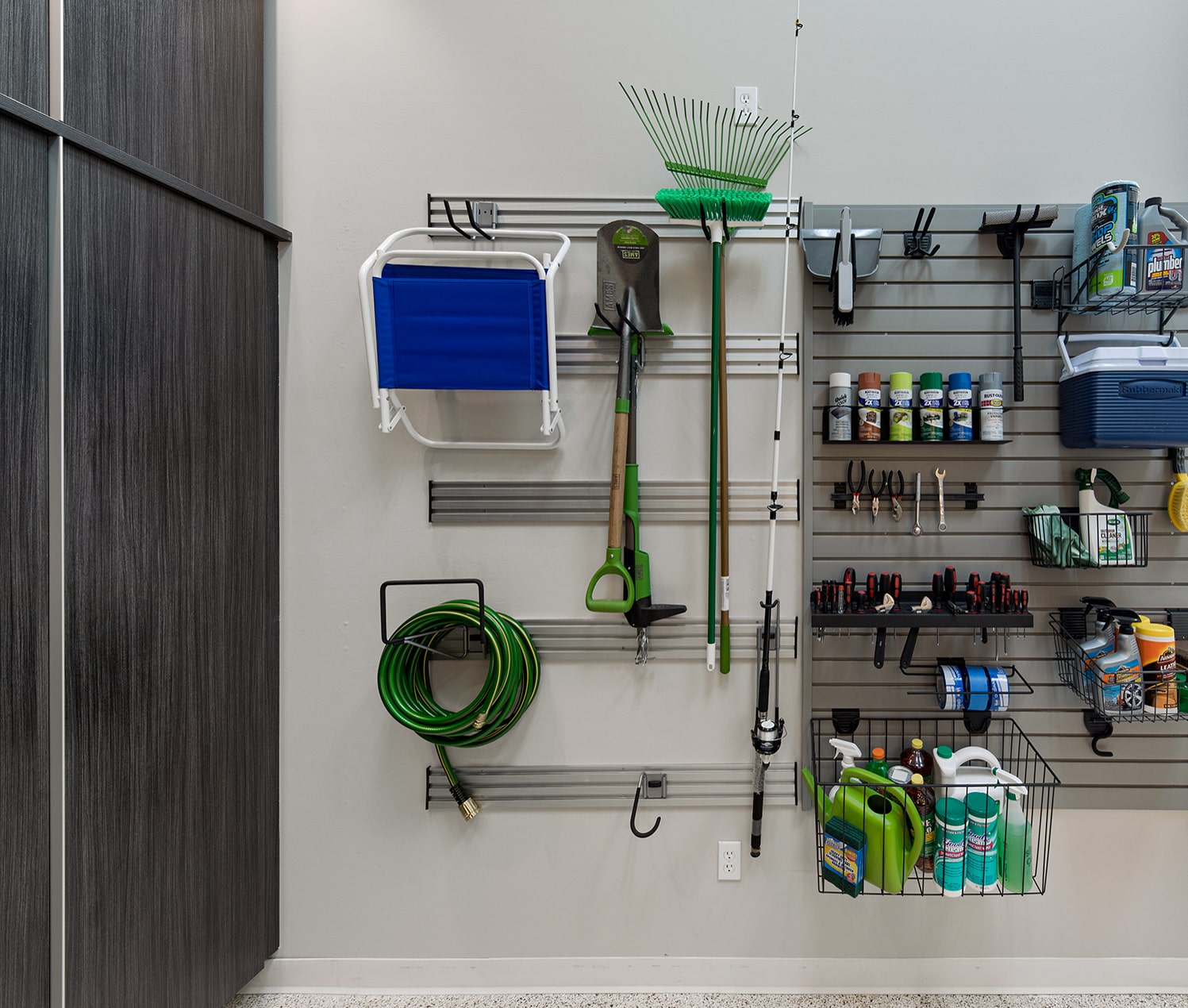 tools hanging on wall in garage with mounts