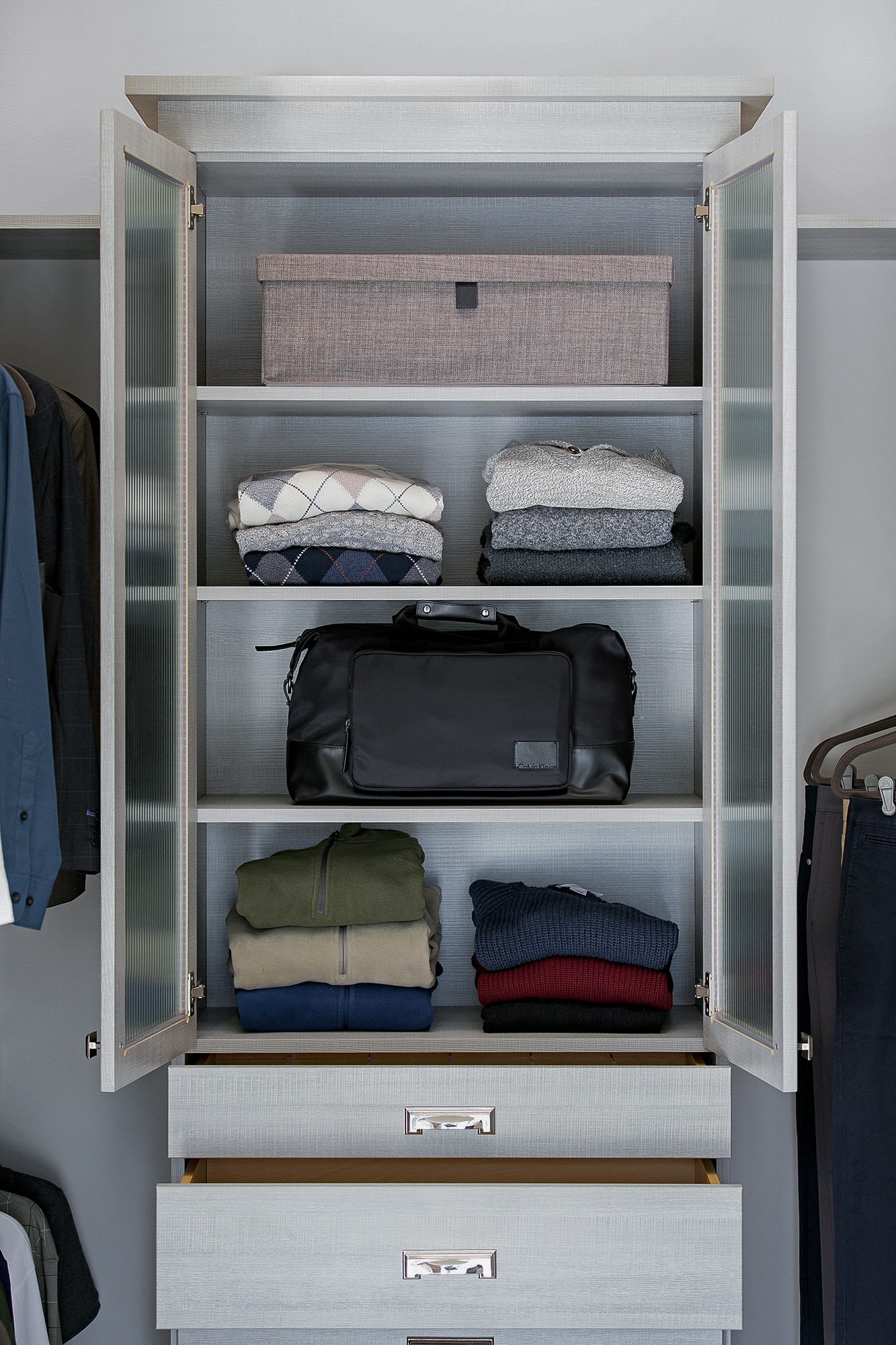 Close up of chest in walk in closet with doors open showing clothes inside