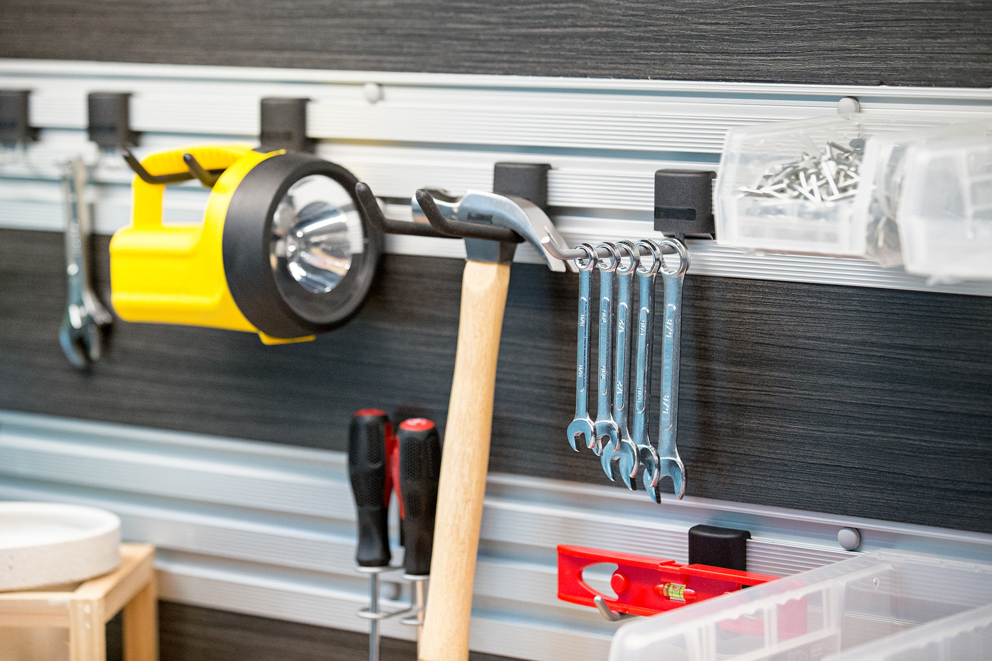 Close up of tools hung up on wall mounts