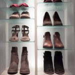 Glass and wood shelves with shoes placed on top