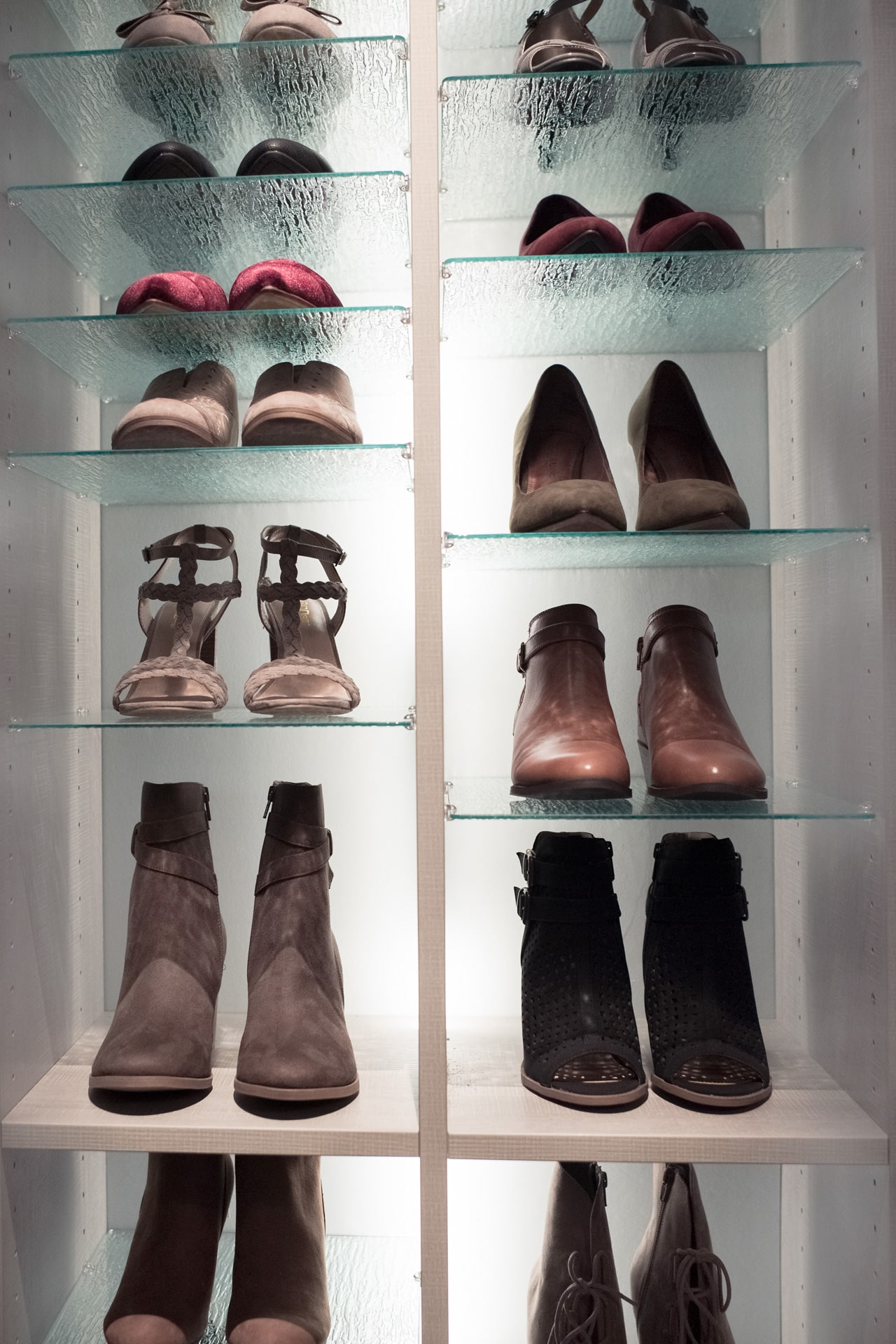 Glass and wood shelves with shoes placed on top