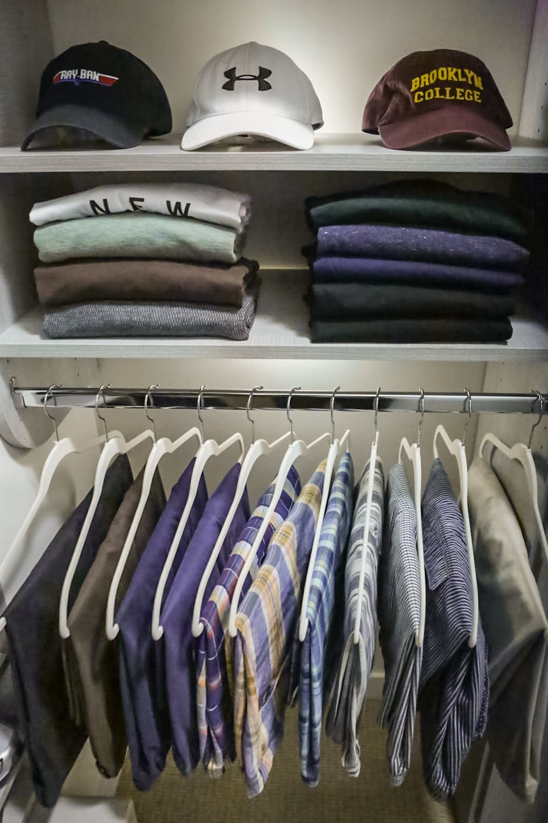 Close up of Inspired Closets closet with shelves and a clothing rack
