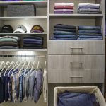 Close up of Inspired Closets closet with drawers , shelves and a clothing rack