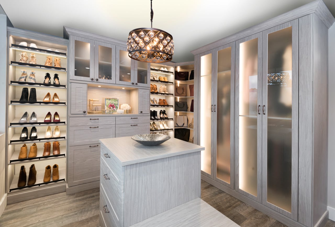 Inspired Closets wall cabinets with shelves for shoes and drawers for other belongings