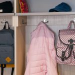 Inspired Closets Closet with Backpacks and a Coat hanging up