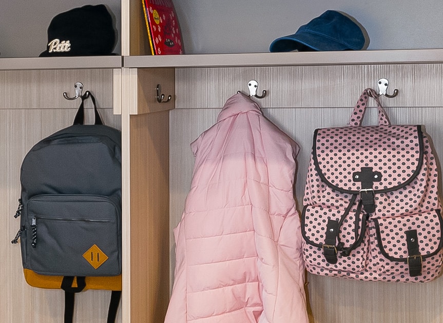Inspired Closets Closet with Backpacks and a Coat hanging up