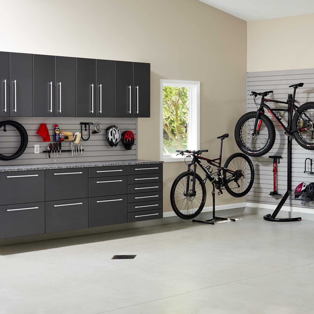 Closets on wall in garage with wall racks by Inspired Closets