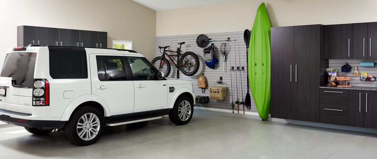 Garage with closets by Inspired Closets on the walls