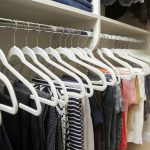 Close up of Inspired Closets closet with clothes on clothing rack