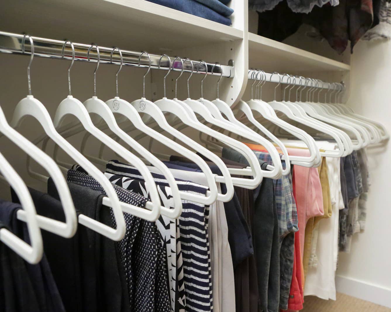 Close up of Inspired Closets closet with clothes on clothing rack