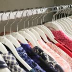 Close up of Inspired Closets closet with clothes on clothing rack