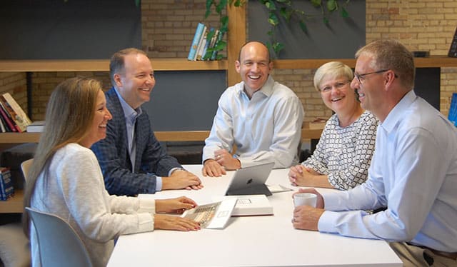 Group of Inspired Closets Leaders Around a Table Having a Discussion