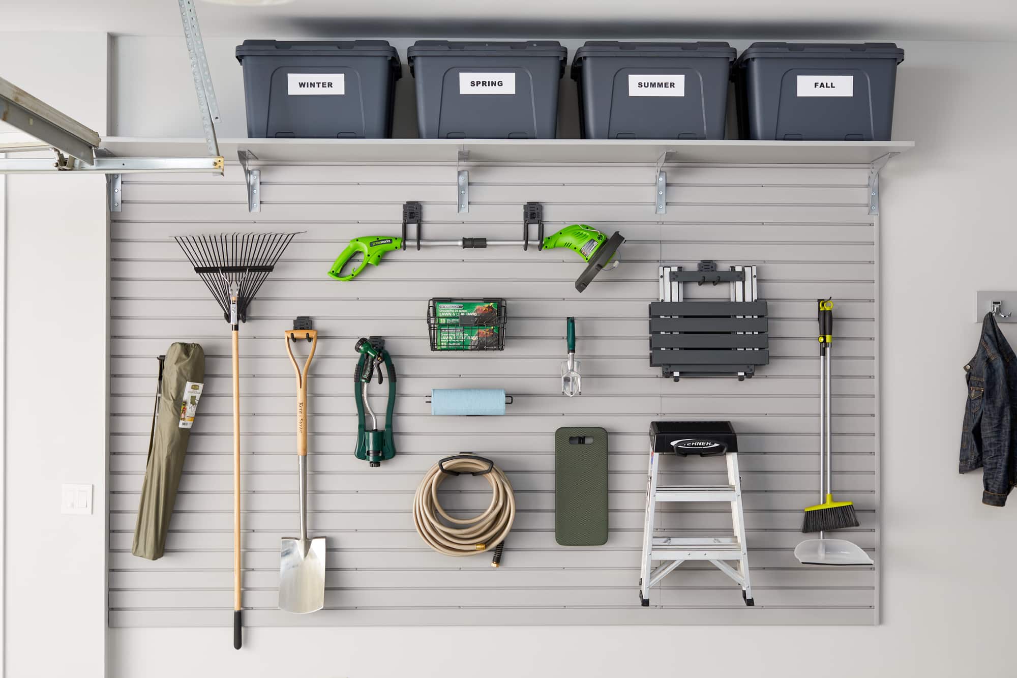 Custom Garage Storage with Sliding Cabinets, Slatwall and Overhead Storage